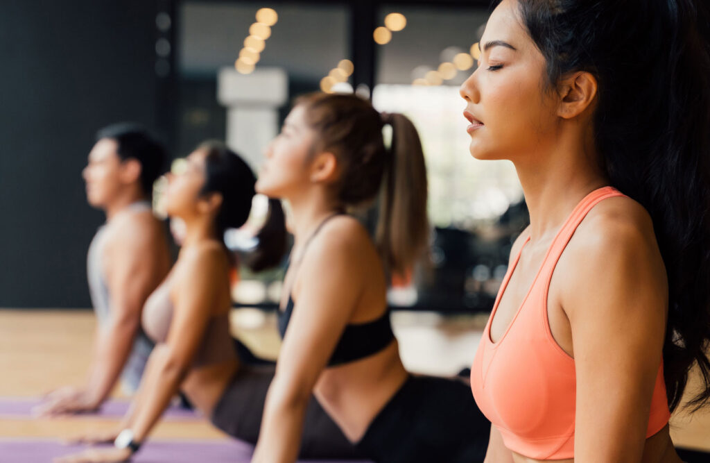 a group of girls doing yoga while meditating